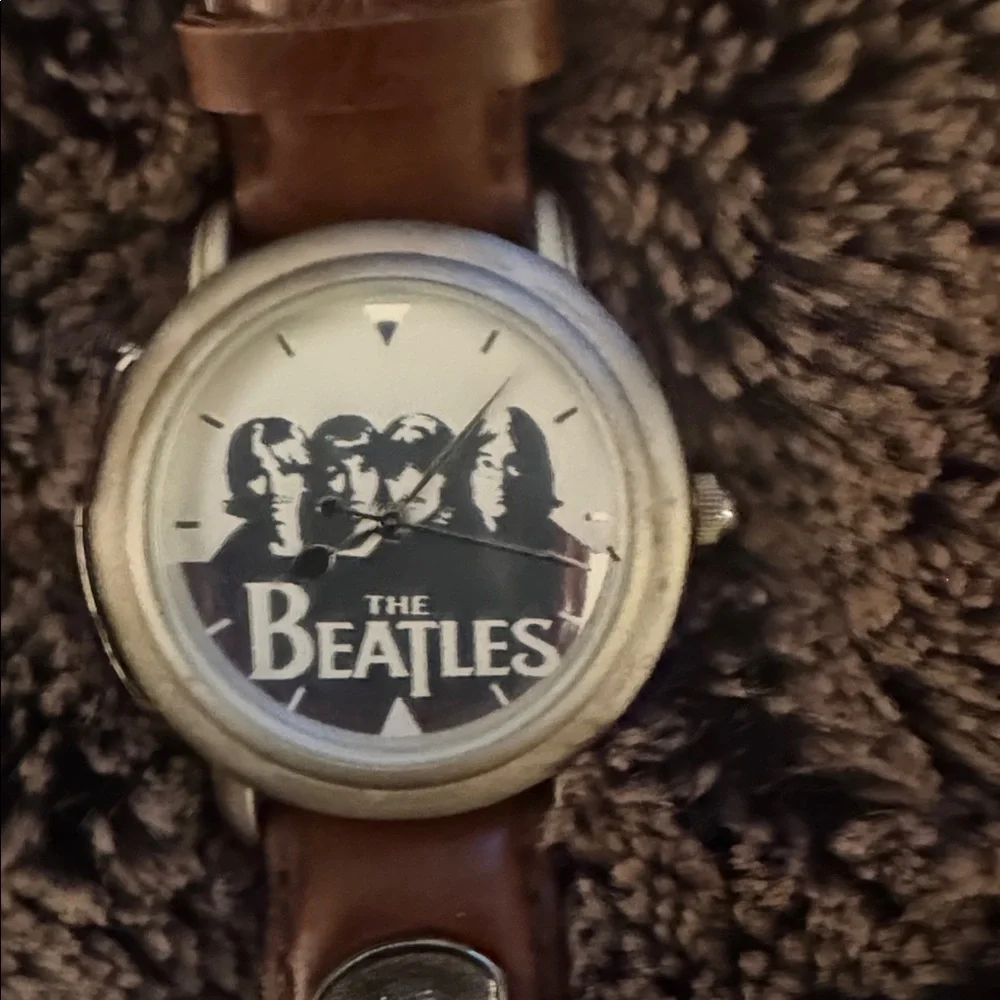 The Beatles Apple Corps Ltd. watch in its original wooden guitar-shaped case.